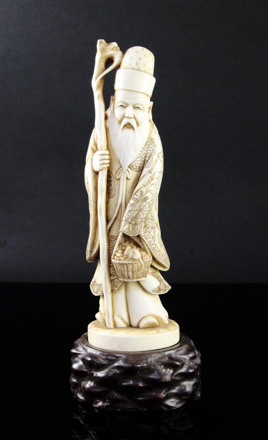 A Japanese ivory figure of a sage, early 20th century, height 25.5cm including wood stand